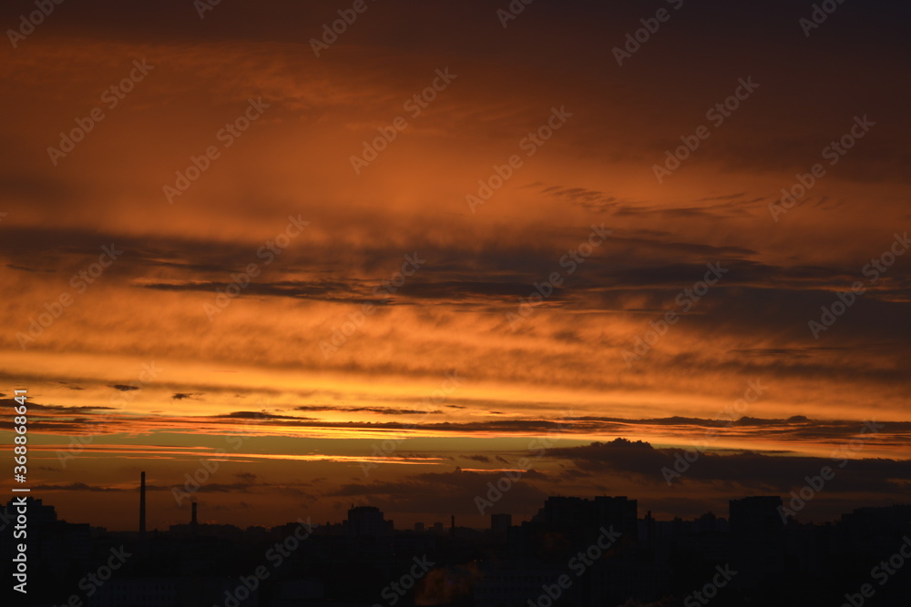 Saint Petersburg Russia August 18 2016. Sunset golden sky with thin clouds, horizontal zigzag lines across heaven