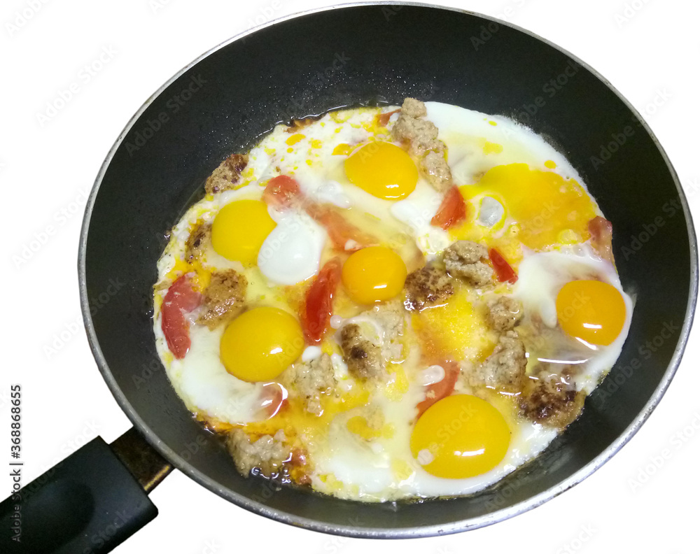 fried eggs with meat and tomatoes in a pan on a white background fried eggs with meat and tomatoes in a pan on a white background