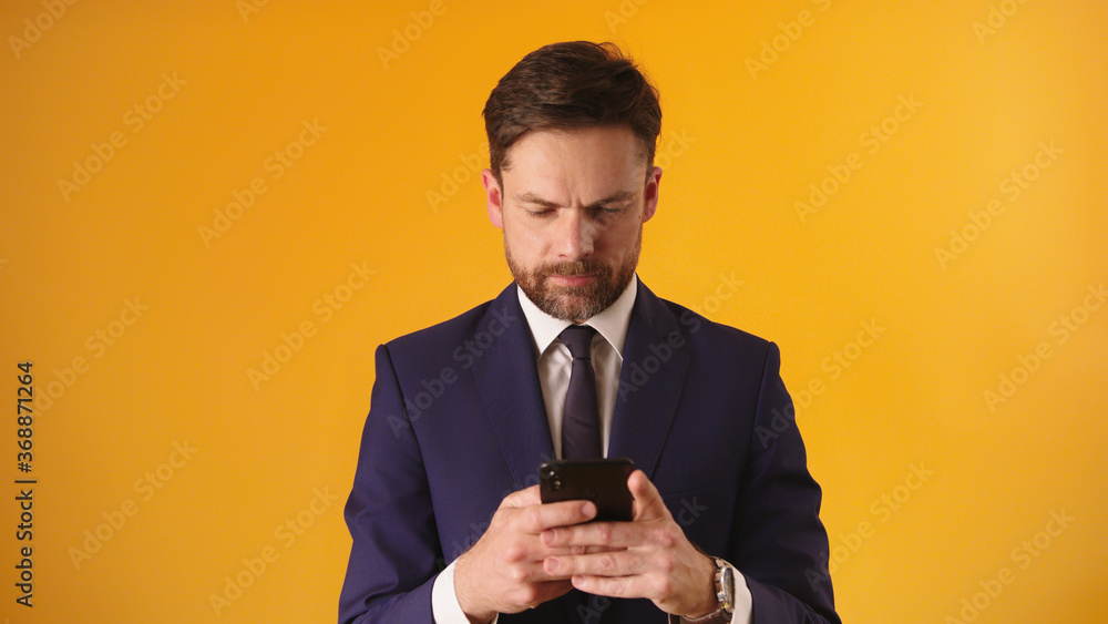 Managing a business with his smartphone. Bearded caucasian businessmen sending sms. High quality photo Managing a business with his smartphone. Bearded caucasian businessmen sending sms. High quality photo
