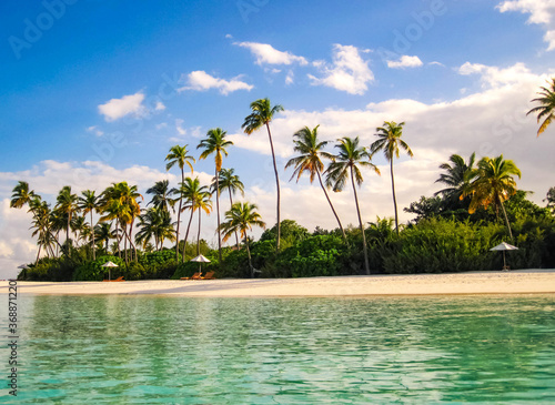 Tropical paradise beach with white sand and coco palms. Travel tourism wide panorama background concept. © Albina