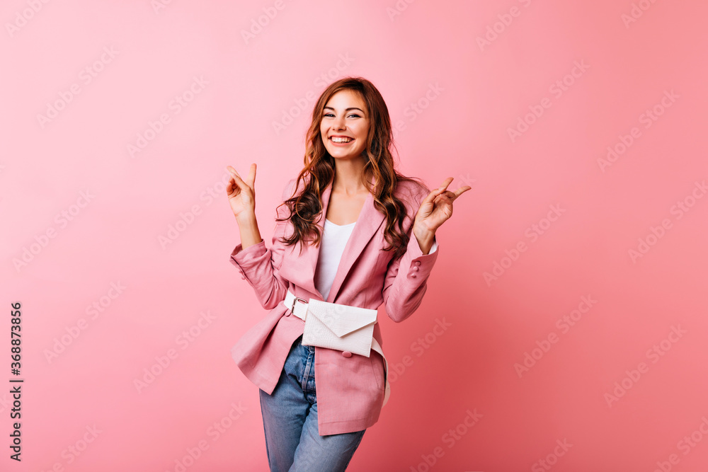 Inspired slim girl has a good time in studio. Amazing caucasian lady in pink jacket smiling to camera. Inspired slim girl has a good time in studio. Amazing caucasian lady in pink jacket smiling to camera.