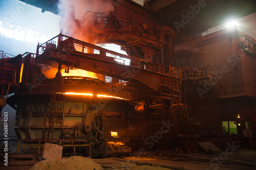 Metal structures and buildings of the old metallurgical plant inside and outside. The process of melting metal. Products of the metallurgical enterprise.