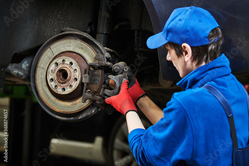 Automobile brake pads replacement in car repair shop or garage