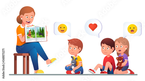 Kindergarten teacher reading to kids a book story