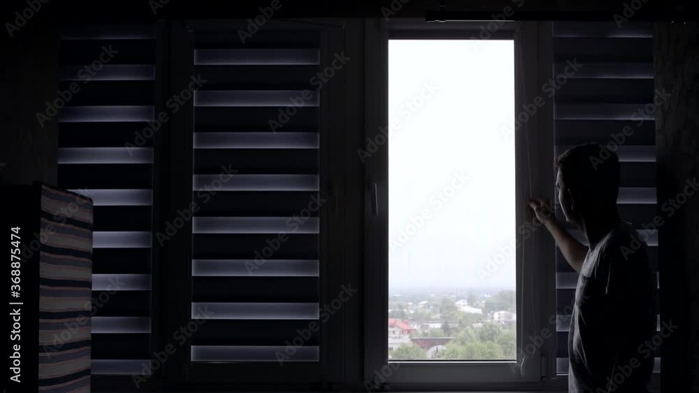 Man installing cassette roller blinds on windows Man installing cassette roller blinds on windows