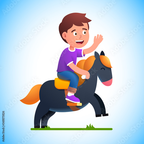 Preschool kid boy play riding toy horse