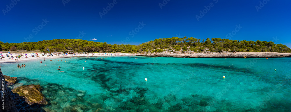 CALA MONDRAGO, Majorka, Spain, 24 July 2020 - People enjoy the beach in summer, Parque Natural de Mondrago. Santanyi. Malorca. Spain