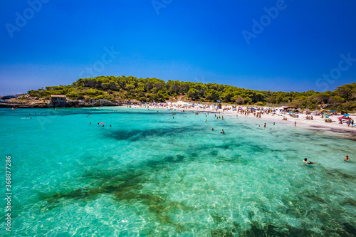 CALA MONDRAGO, Majorka, Spain, 24 July 2020 - People enjoy the beach in summer, Parque Natural de Mondrago. Santanyi. Malorca. Spain © Martin Valigursky