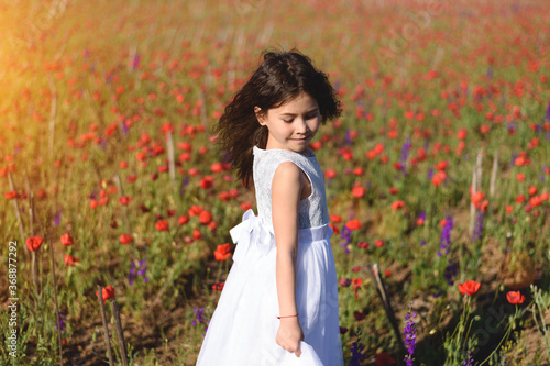 A portrait of young girl on the poppy field.