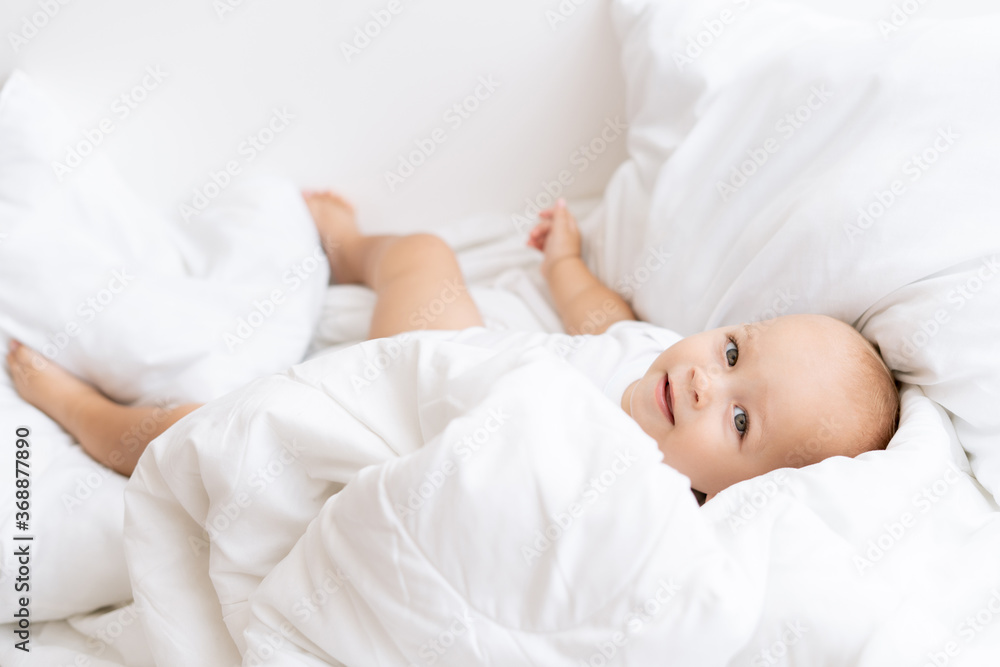 kid boy on white bed kid boy on white bed