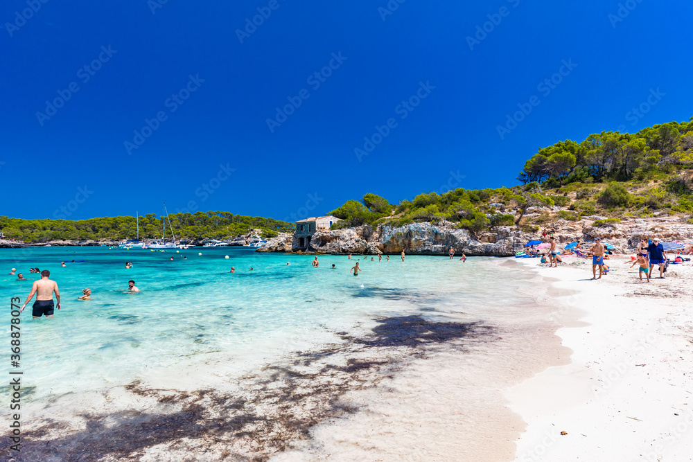 CALA MONDRAGO, Majorka, Spain, 24 July 2020 - People enjoy the beach in summer, Parque Natural de Mondrago. Santanyi. Malorca. Spain CALA MONDRAGO, Majorka, Spain, 24 July 2020 - People enjoy the beach in summer, Parque Natural de Mondrago. Santanyi. Malorca. Spain