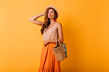 Jocund woman in summer skirt posing with kissing face expression. Indoor photo of relaxed elegant ginger lady enjoying leisure time in studio.