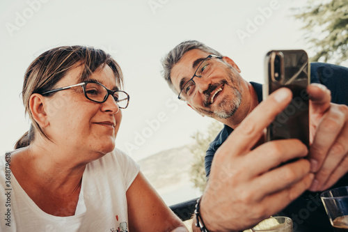 Adult couple smiling with mobile.