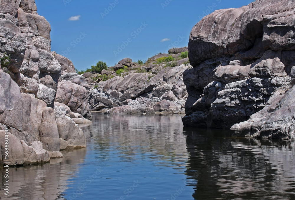 Explore. Geology. View of the river flowing along the rocky cliffs called The Elephants in Mina Clavero, Cordoba, Argentina. 