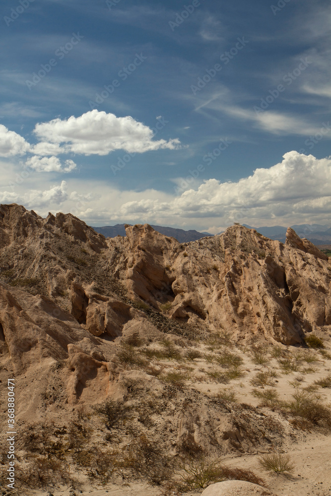 Vertical photo. Arid landscape. Geology. View of the dry valley, sandstone and rocky hills.