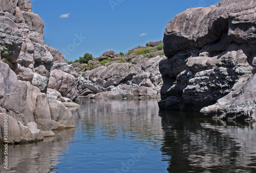 Explore. Geology. View of the river flowing along the rocky cliffs called The Elephants in Mina Clavero, Cordoba, Argentina.  © Gonzalo