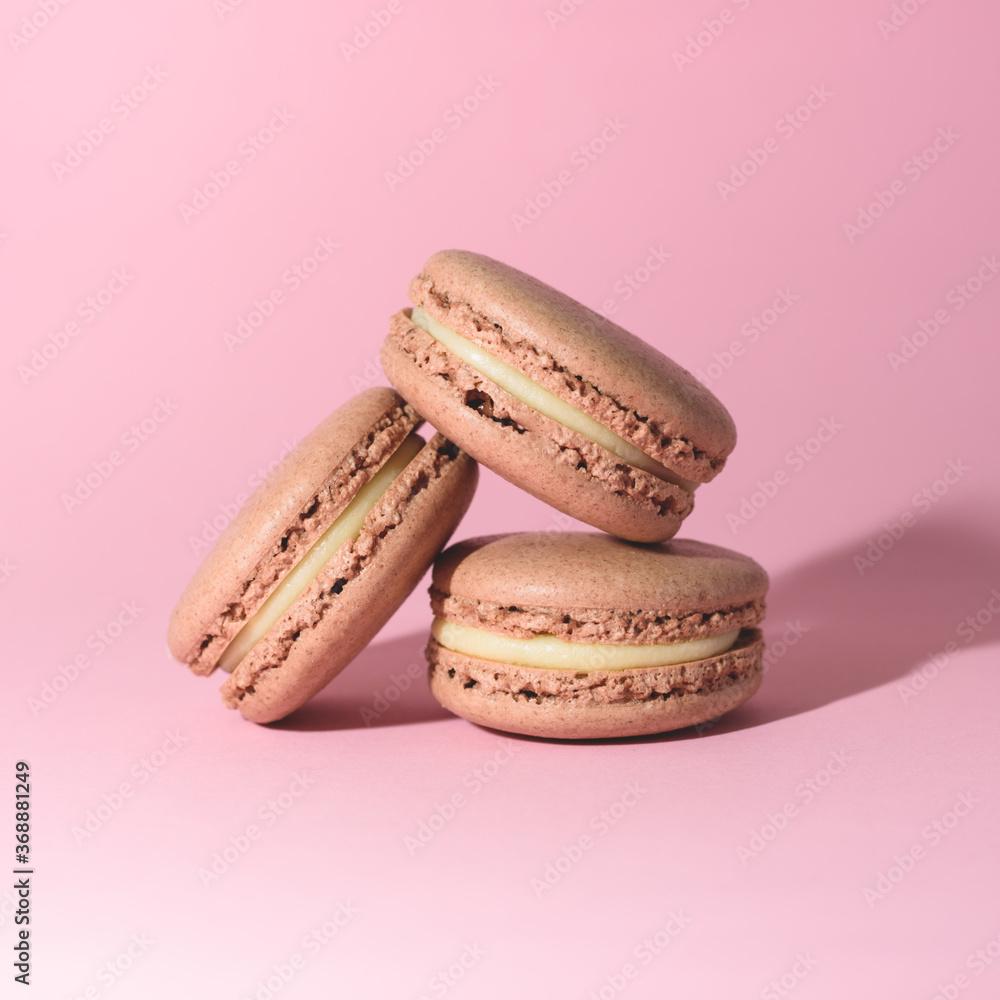 Three tasty macarons on the bright background.
