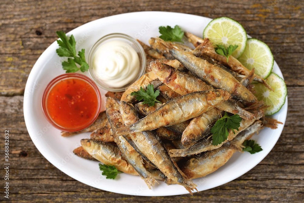 Grilled little fish in cornmeal and lime. On an old wooden background. Grilled little fish in cornmeal and lime. On an old wooden background.