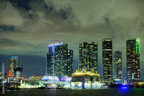 Cruise ship in the Port of Miami at sunset with multiple luxury yachts. Miami, Florida, USA.