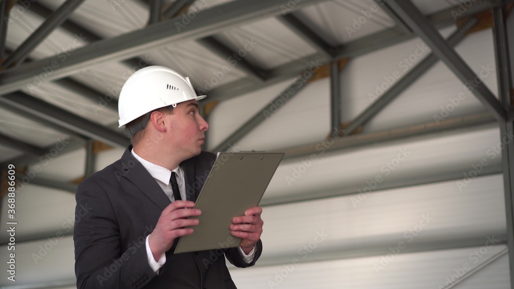 A young man in a helmet scared. The boss in a suit keeps records of documents and he was suddenly scared. The man turns around and swears. A young man in a helmet scared. The boss in a suit keeps records of documents and he was suddenly scared. The man turns around and swears.
