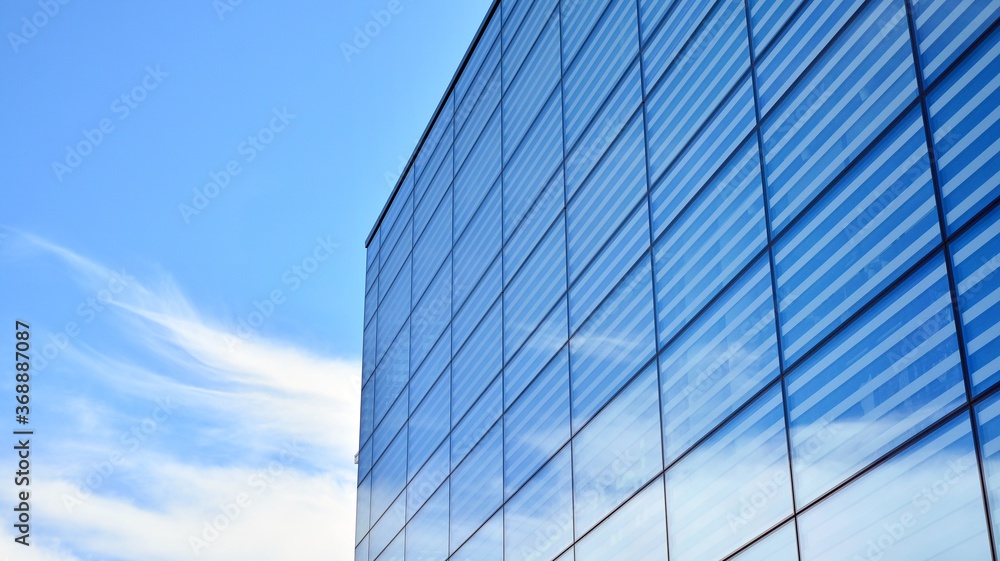 Commercial building close up. Abstract texture of blue glass modern building. Business background. Commercial building close up. Abstract texture of blue glass modern building. Business background.