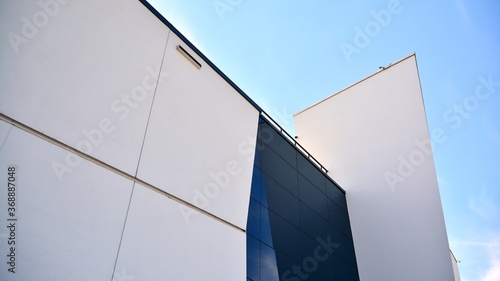 Abstract image of looking up at modern glass and concrete building. Architectural exterior detail of office building. Industrial art and detail.