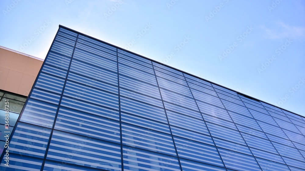 Commercial building close up. Abstract texture of blue glass modern building. Business background. Commercial building close up. Abstract texture of blue glass modern building. Business background.