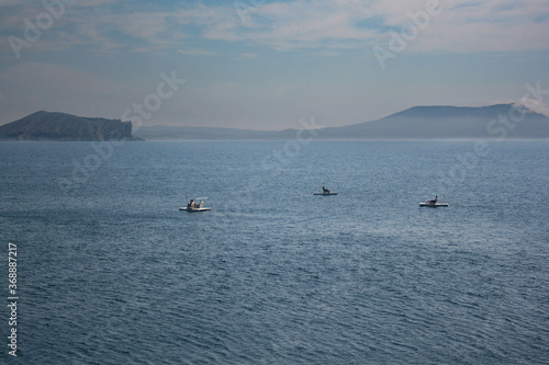 three catamarans in the black sea near the mountains