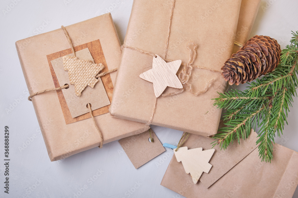 several boxes of gifts packed in eco paper on the table, zero waste lifestyle concept, packaging for DIY gifts, top view, gray background, eco christmas several boxes of gifts packed in eco paper on the table, zero waste lifestyle concept, packaging for DIY gifts, top view, gray background, eco christmas
