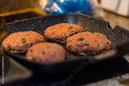 Grilled burgers with dancing flames cooked to perfection