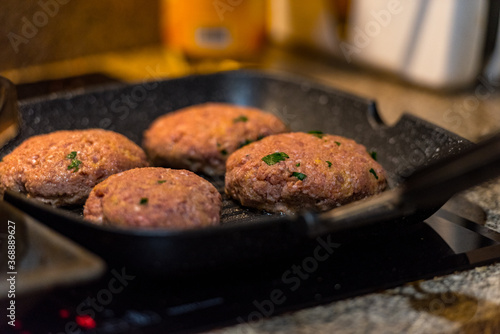 Grilled burgers with dancing flames cooked to perfection