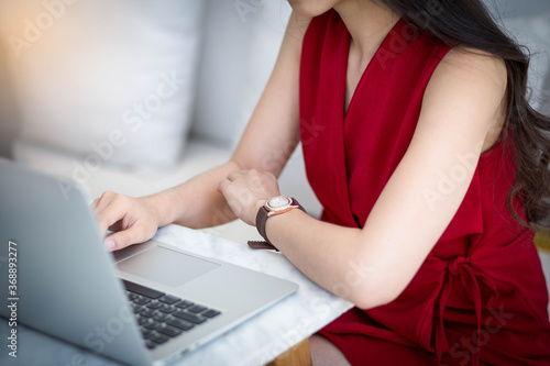 woman working on laptop in home, selective focus.