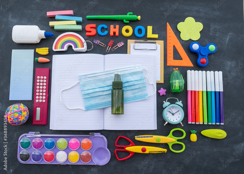 Stationery chalk board. Back to school. Open notepad on top of office supplies. Stationery chalk board. Back to school. Open notepad on top of office supplies.