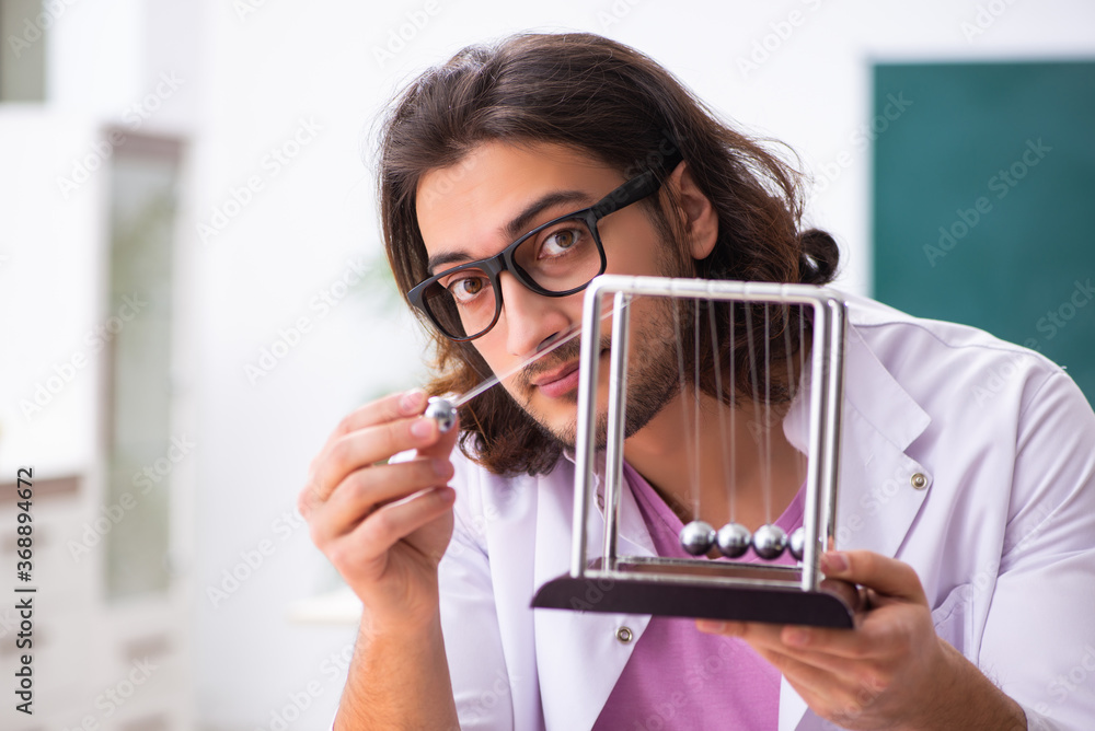 Young male physicist in the classroom Young male physicist in the classroom