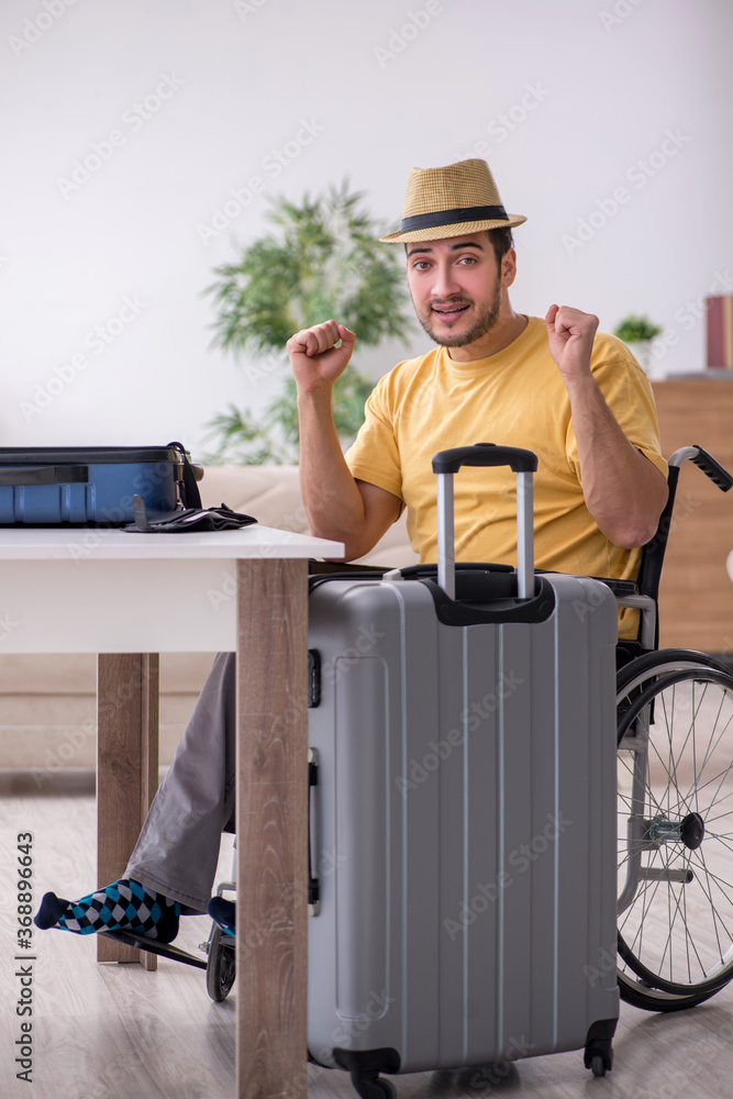 Young man in wheel-chair preparing for departure at home