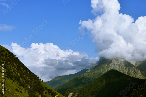View of the beautiful countryside of North Ossetia. Sunny day. Beautiful summer landscape in the mountains. Grassy fields and hills. Rural landscapes