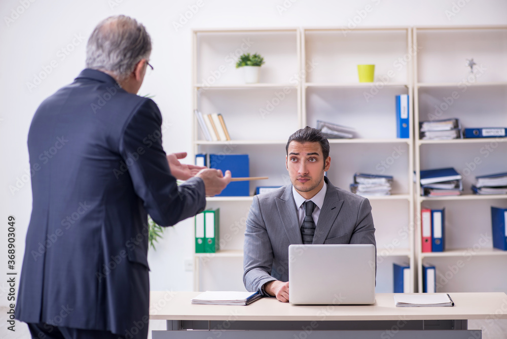 Old and young businessmen in business meeting concept