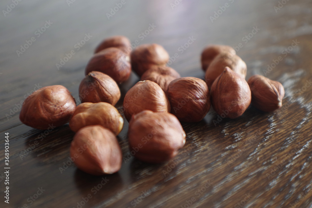 Heap of peeled hazelnuts. Hazel nuts. Organic peeled hazelnuts on Wooden Background. 