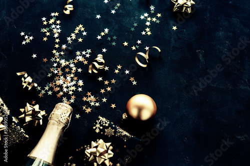 Christmas background  with bottle of champagne , gold  decorations, stars,  b...