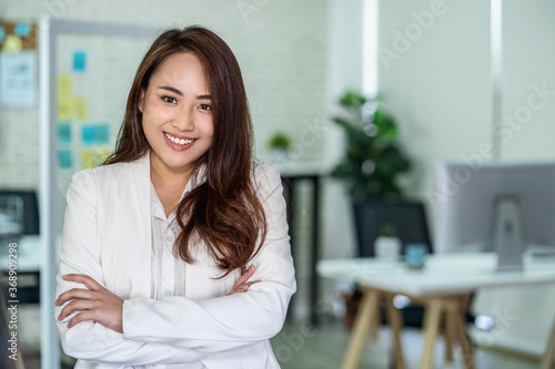 Free Download Portrait of Asian Business woman with Arms Crossed and standing at modern workplace, human resource and small business owner, hiring new employee, business person concept - GFXLoad