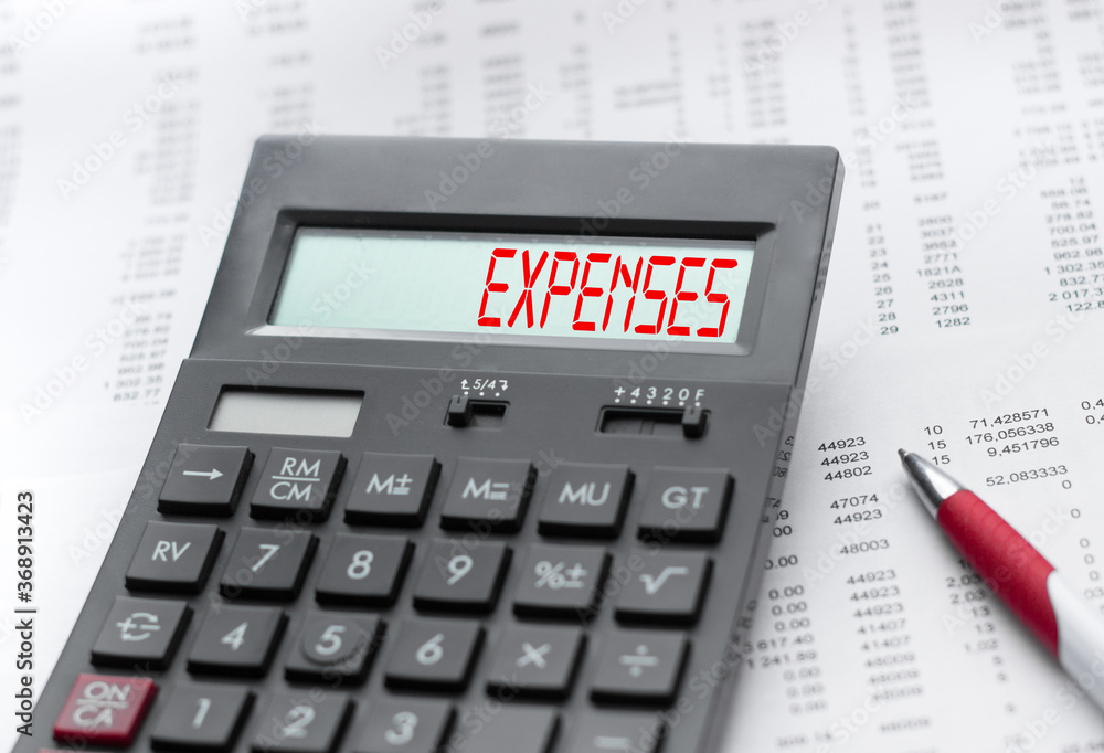 A calculator with the inscription EXPENSES . Business profit concept A calculator with the inscription EXPENSES . Business profit concept