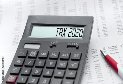 A calculator with the inscription TAX 2020 . Business profit concept