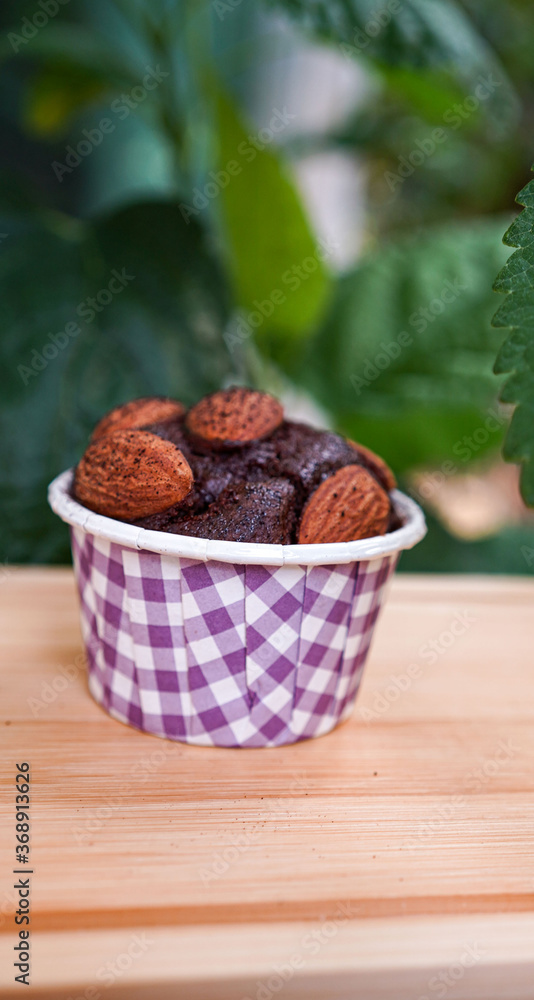 Dark chocolate almonds in a purple cup Dark chocolate almonds in a purple cup