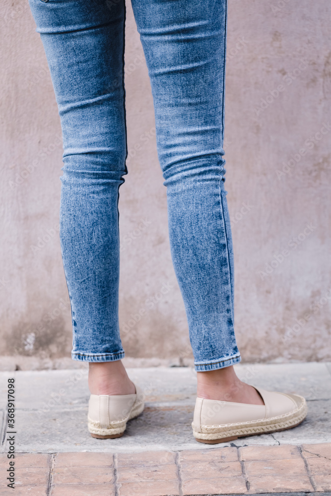 Happy Asia woman in bright blue skinny crop jeans, sky blue jeans Happy Asia woman in bright blue skinny crop jeans, sky blue jeans