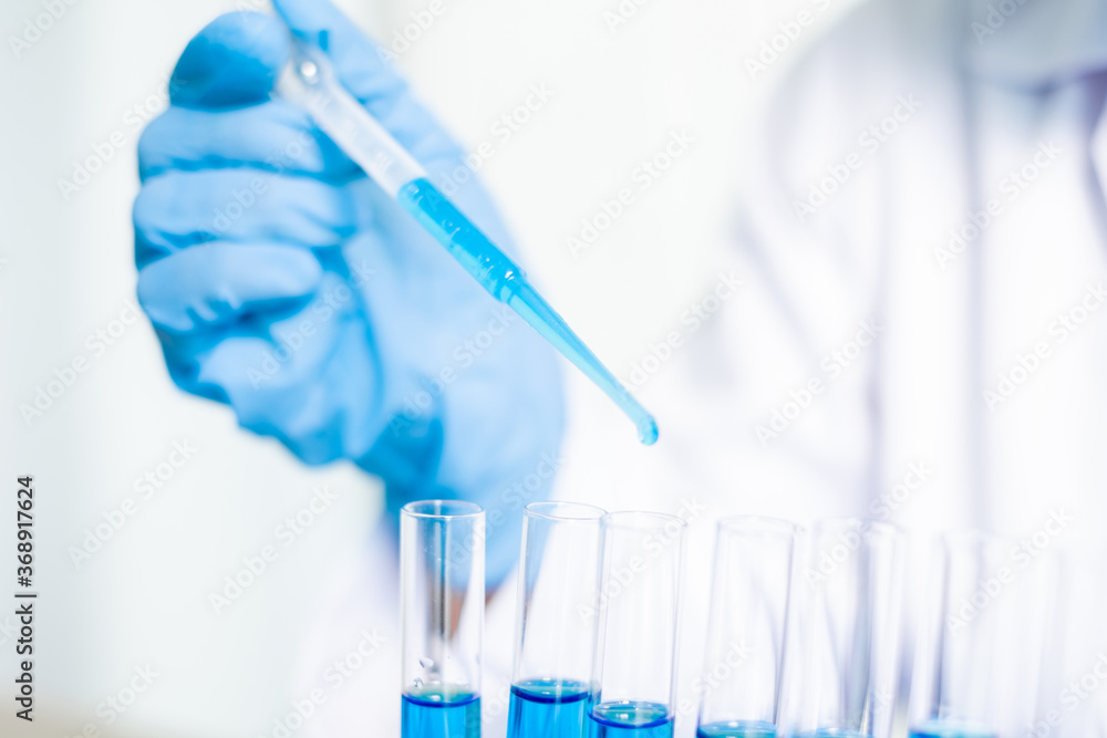 Medical scientists released a sample pipette into a test tube to analyze the virus in a chemical laboratory. Scientific research concepts Medical scientists released a sample pipette into a test tube to analyze the virus in a chemical laboratory. Scientific research concepts