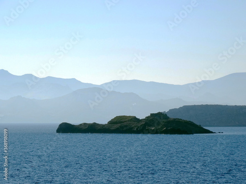 Natural landscape and seascape with misty islands in Aegean Sea in Greece. Paros located at the heart of the? Cyclades, one of famous Greek travel destinations for tourism and vacation. © isparklinglife