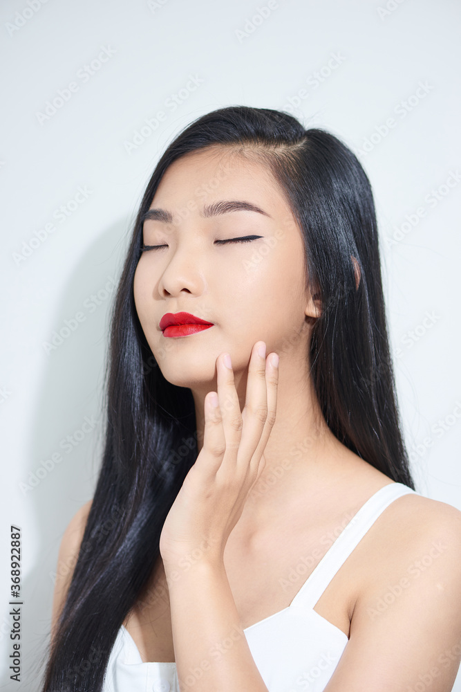 Portrait of young beautiful girl smiling with closed eyes touching face over white background. Portrait of young beautiful girl smiling with closed eyes touching face over white background.