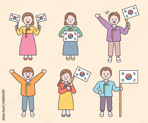 Cute characters wearing traditional Korean costumes are holding the Korean flag. flat design style minimal vector illustration.