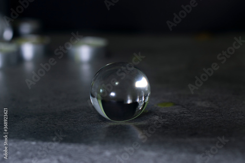 The crystal ball is placed on the reflective surface.