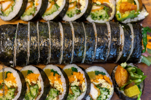 Korean kimpab rolls with vegetables and chicken on board, view above